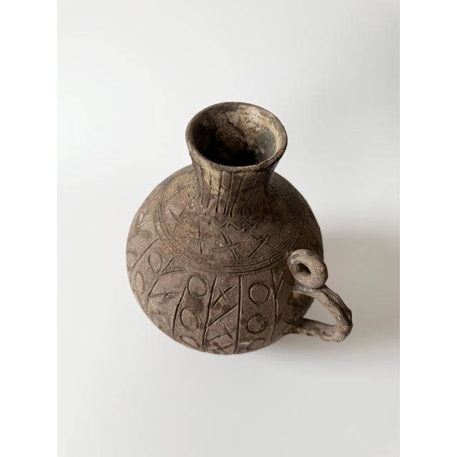 Stunning brown ceramic antique Chinese seed pot with etched markings. Measures 10" tall and 9" across.