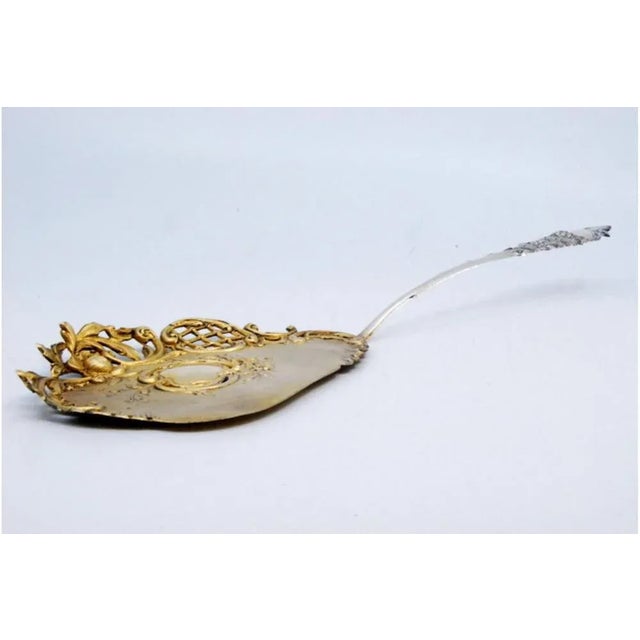 Cake Shovel in Gilded Silver and Cut Out with Shells, in Very Good conditions. Designed 1890 to 1919 This piece has an...