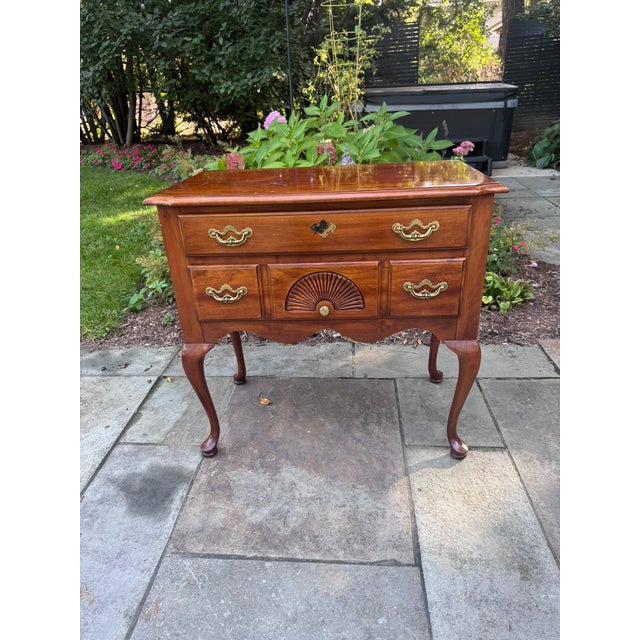 A classic Queen Anne–style lowboy by Thomasville, made of cherry with a warm, rich finish and lots of traditional detail....