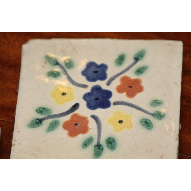 A beautiful set of 9 hand-painted, terra cotta tiles from Mexico. There are 5 tiles that are 4"x4" and 4 tiles that are...