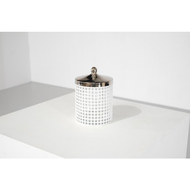 White lacquered metal sugar bowl, glass, metal lid. Manufacturer's label underneath. Designed by Josef Hoffmann for...