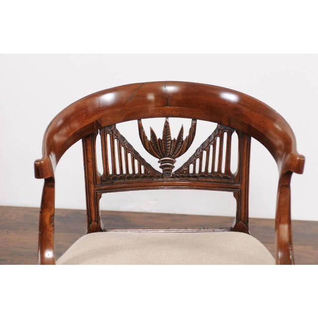 Two Italian walnut armchairs from the early 19th century with pierced splats, wraparound backs and new upholstery, priced...