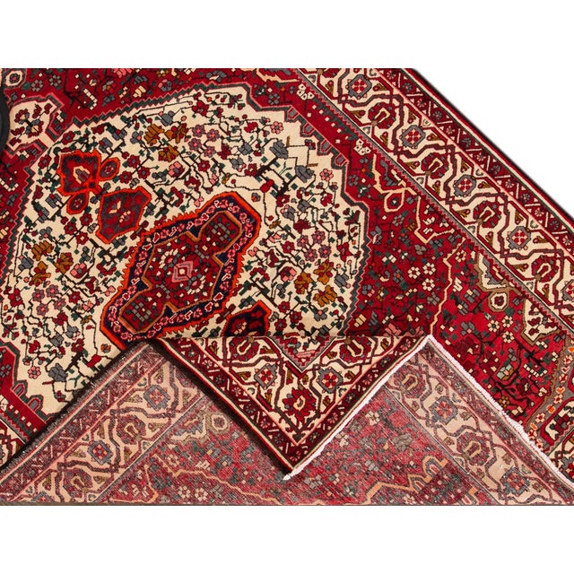 Beautiful Vintage hand-knotted wool Persian Bakhtiari rug with a medallion design on a red field. Very good condition. Rug...