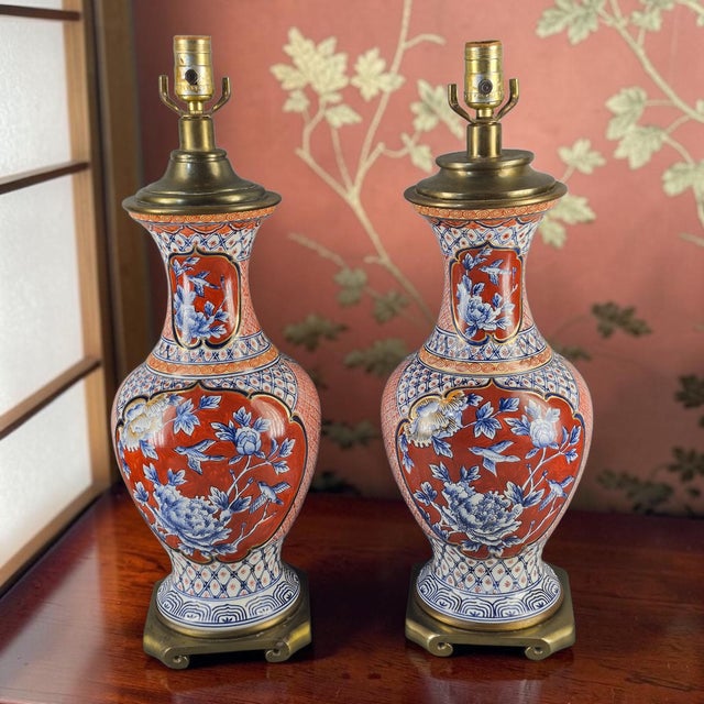 This pair of vintage elegant table lamps features a beautiful Asian-inspired design with a floral pattern on porcelain,...