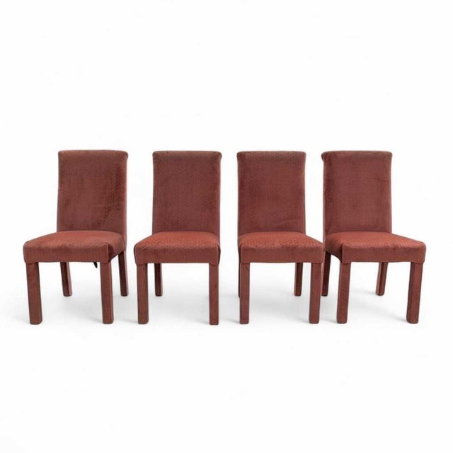 A rare Postmodern find: a striking set of four dining chairs in salmon-pink velvet, blending late-1980s sculptural...