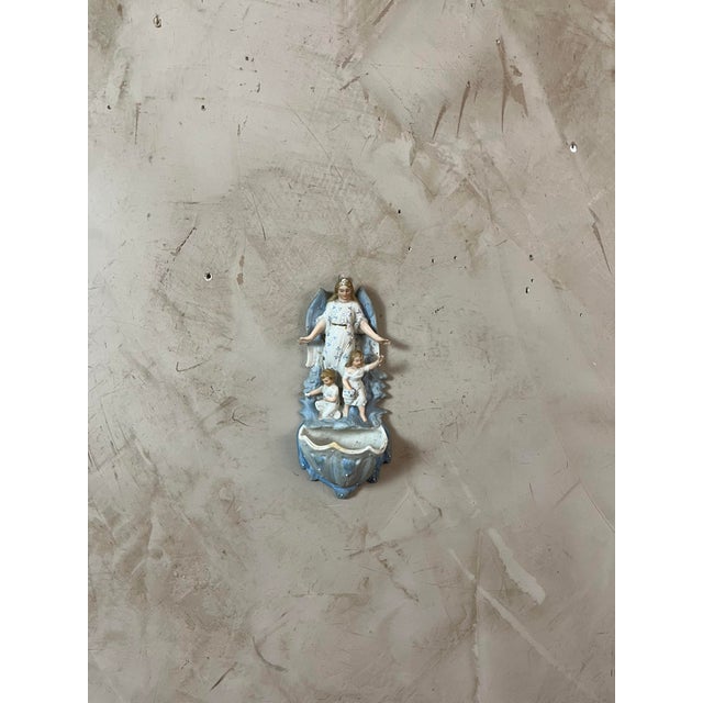 Antique bisque wall-mounted holy water font dating from 1900. Depicting a guardian angel watching over two children, this...