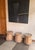 A striking antique teak wood side table originating from Java, Indonesia, showcasing the enduring beauty of aged timber...