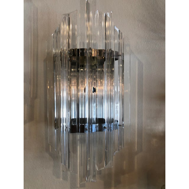 Vintage 1970s pair of lucite and chrome wall light sconces. Ready to hang.