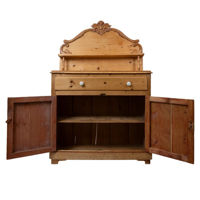 A handsome and generously scaled late 19th century French pine sideboard, featuring a warm honey-toned finish and a...