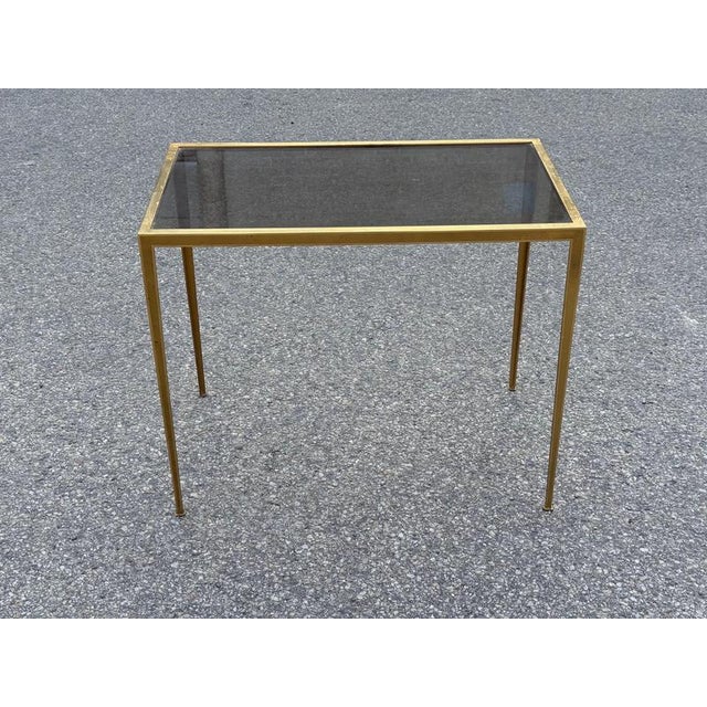 Elegant Mid-Century Modern Brass Side Table with Smoked Glass, 1960s An elegant Mid-Century Modern side table featuring a...