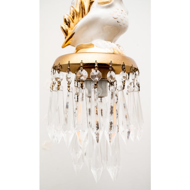 An exceptional and architecturally scaled pair of Hollywood Regency figural wall sconces, measuring an impressive 25...