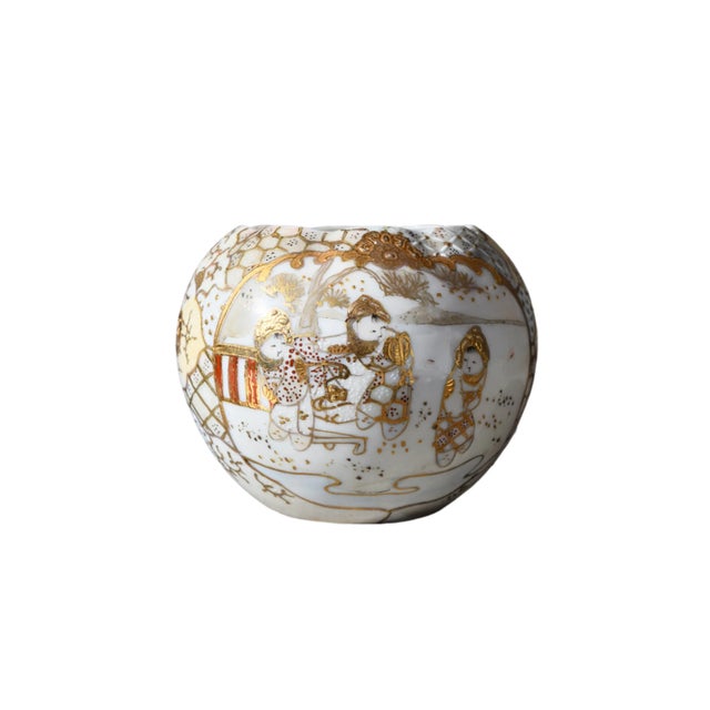 JAPANESE SATSUMA-STYLE PORCELAIN VASE Era: Early 20th Century (Circa 1940s) Style: Moriage Satsuma OVERVIEW: A petite...