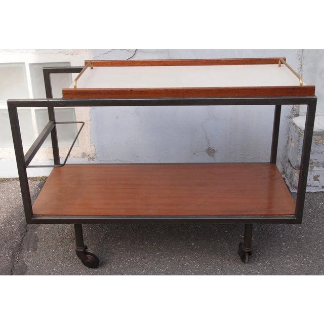 This table on wheels by Boris Lacroix is made from Formica, grey lacquered metal, brass, and oak.