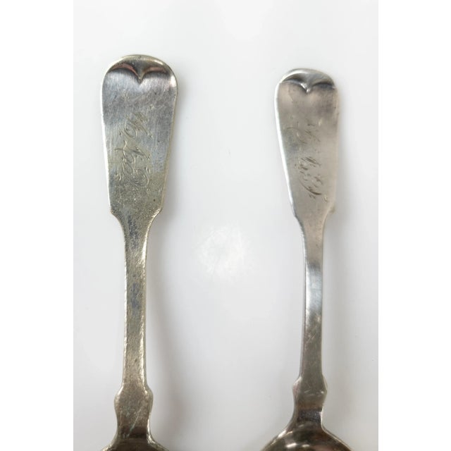 We are selling this pair of salt or mustard spoons by Hall & Elton of Geneva. The spoons appear to be silverplate and one...