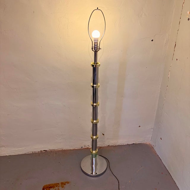 Sleek and sophisticated, this vintage floor lamp blends polished chrome with warm brass accents for a timeless modern...