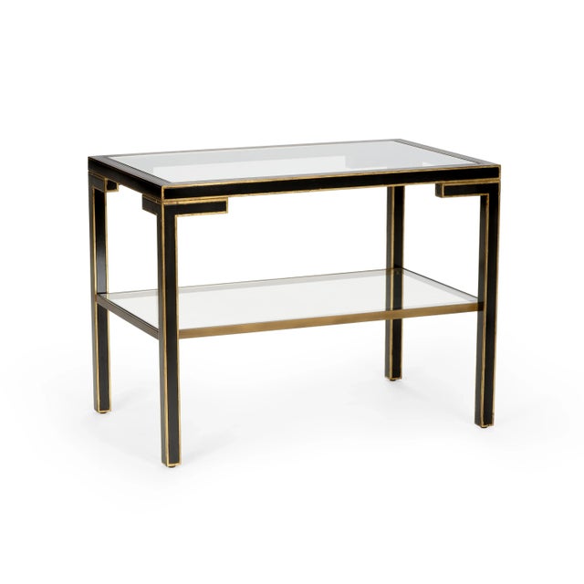 This is the Decker cocktail table by Chelsea House Inc. The piece is made of wood and features gold accents, a glass top,...