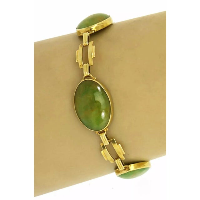 This gorgeous vintage bracelet is crafted from 14k yellow gold with a polished finish. It has three oval links, each with...