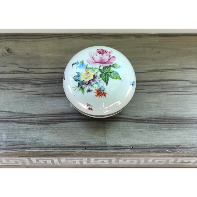 This vintage Herend porcelain floral trinket box is truly a one of a kind. Accented in gold trim and covered in flowers...