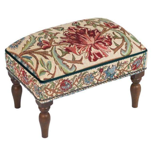 Meticulously handcrafted in the United Kingdom, this upholstered stool boasts classic studding and hand-polished solid...