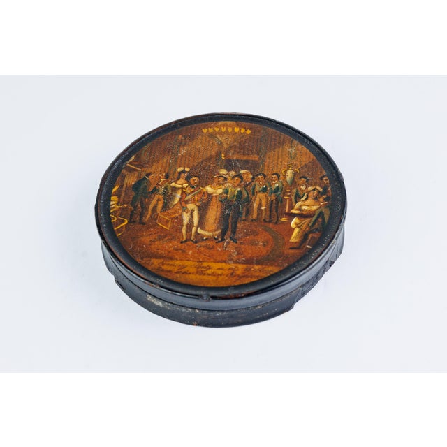 A wonderful antique lacquered papier-mâché box, Continental (likely German, Brunswick tradition), 18th century. The lid is...