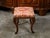 An English Regency period mahogany stool from the early 19th century, with cabriole legs and floral upholstery. Created in...