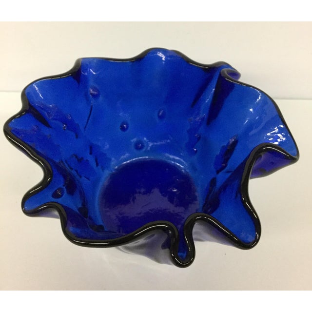 The vase is made from Cobalt Glass, a type of glass that was highly prized for its vibrant blue color and exceptional...