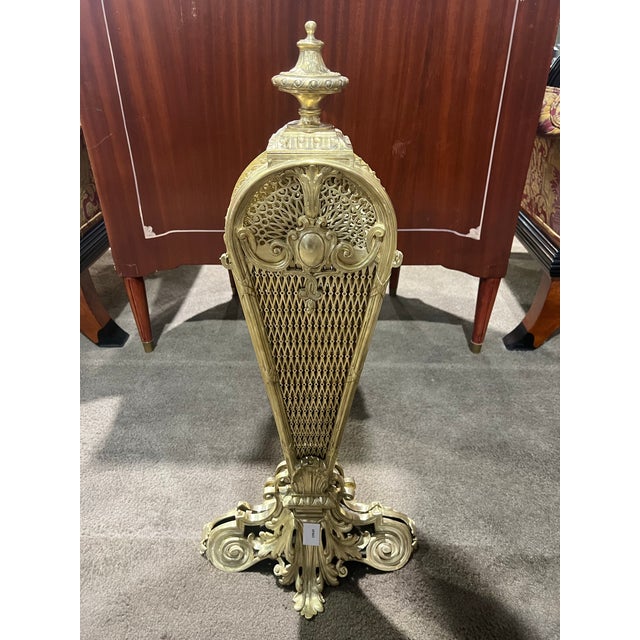 This striking antique fireplace screen is crafted in an elegant peacock-style fan form, showcasing exceptional decorative...