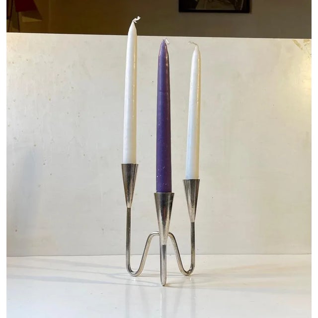 Small silver plated candelabra with tree tiers: 18, 15.5 and 13 cm respectively. Designed and manufactured by Berg in...