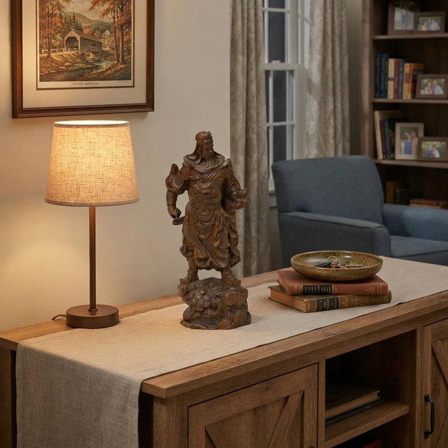 This carved wooden statue depicts a powerful warrior—reminiscent of the historical Chinese general Guan Yu—commanding an...