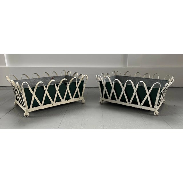 Pair 1930's white painted zinc X-form cachepot planters or jardinieres with green tole liners on ball feet. Each measures...