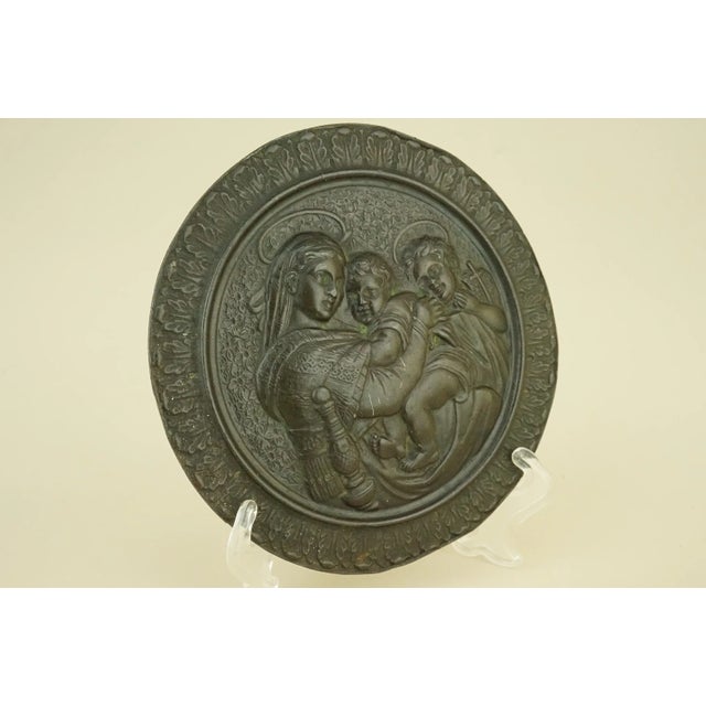 Item description: A stunning bronze medallion, a bas-relief sculpture depicting Raphael's Madonna della Seggiola, dating...