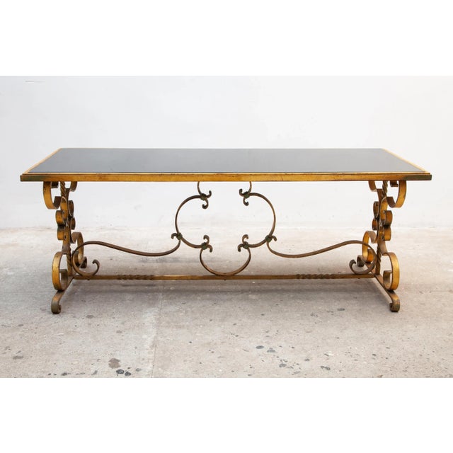 Beautifully Art Deco coffee or centre table with a wrought iron base and the warm original gilded and black smoked...