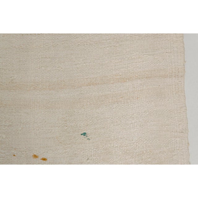 This is a vintage Turkish Oushak rug from the Mid 20th Century. The piece was hand-knotted.