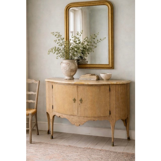 I love this piece! It is a French Louis XV style demilune cab8net with marble top. It has a cerused oak finish with three...