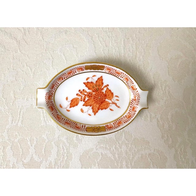 This rare miniature twin-handled porcelain tray, handcrafted by Herend Hungary in the beloved Chinese Bouquet Rust...