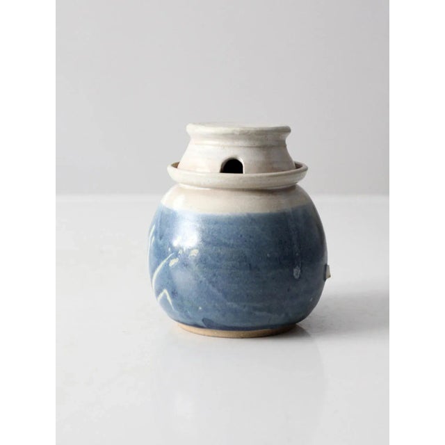 This is a vintage studio pottery jar. Signed by the artist, the handmade honey pot features a blue and white glaze with...