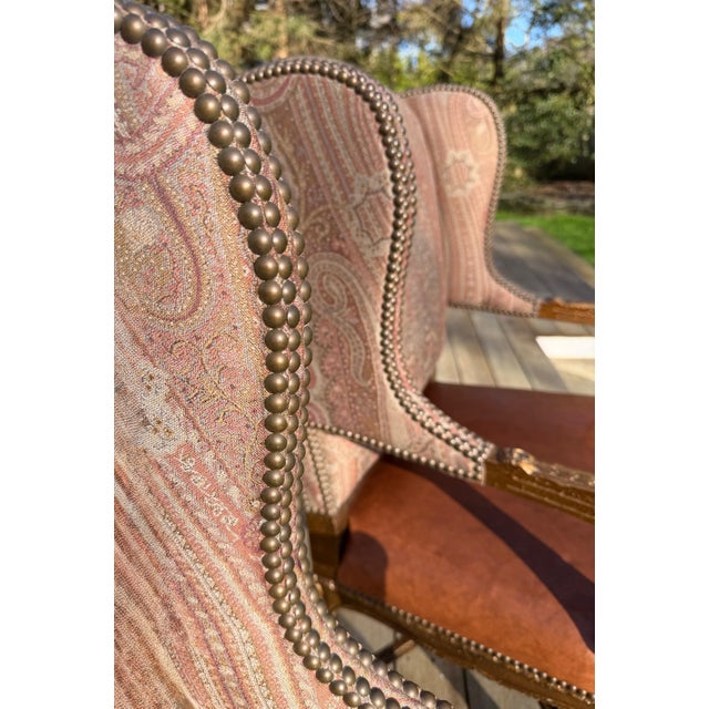 A pair of Custom Ralph Lauren Wingback lounge Chairs with Leather Seats and Paisley Jacquard Upholstery Upholstered in a...