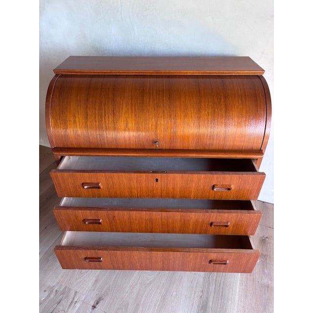 Stunner of a piece with the most beautiful old growth teak wood graining we've seen! Lockable rolltop with original key,...