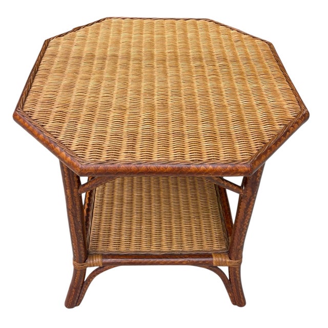 A vintage Palecek side table with a rich tortoise-toned rattan finish that gives the piece more depth than typical natural...