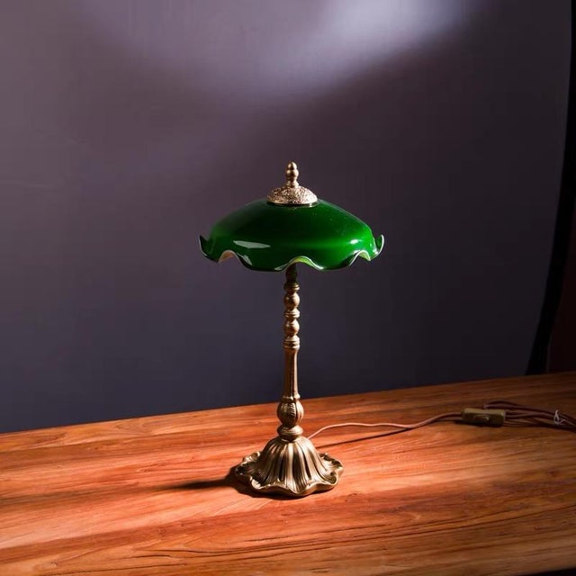 Shade is dark green wave-edge glass (soft light transmission with rich texture), body is retro copper carved shape (column...