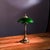 Shade is dark green wave-edge glass (soft light transmission with rich texture), body is retro copper carved shape (column...