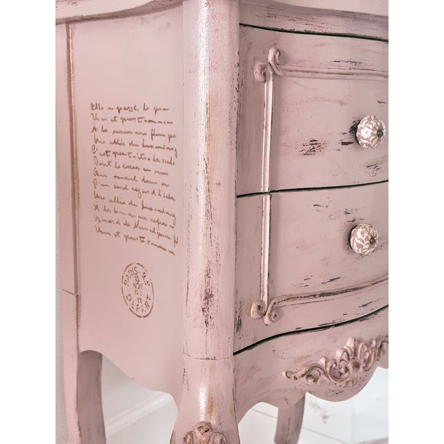 This charming petite nightstand features a romantic French-inspired silhouette finished in a soft blush pink with delicate...