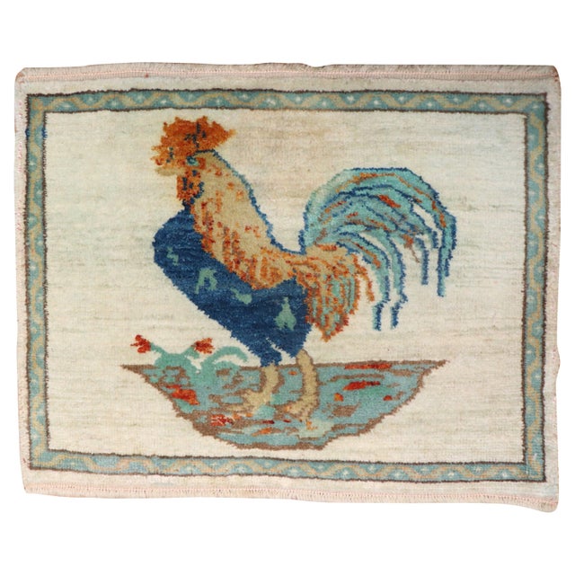 Vintage Turkish mat size rug depicting a rooster on an ivory field. Measures: 1'6" x 1'11''.