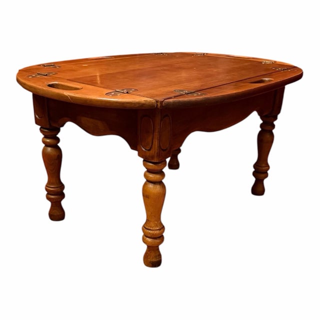 Vintage circa 1950s maple butler’s tray table with a classic folding four-sided top, recessed handholds, turned legs, and...