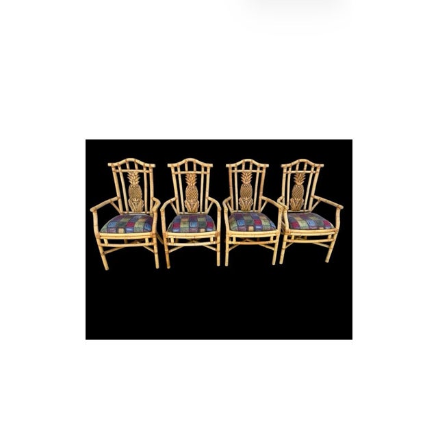 Exceptional set of four vintage rattan and bamboo armchairs featuring dramatic hand-carved pineapple-form back splats....