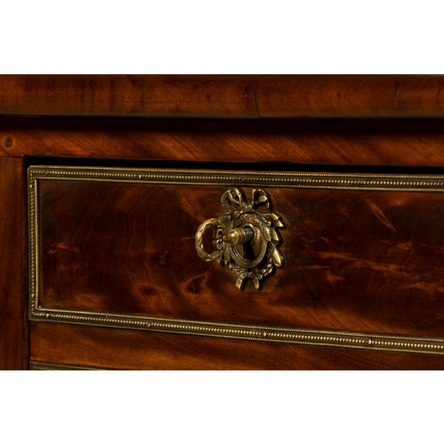 Sourced in Provence, France, this mid-19th century French Neoclassical bureau plat is crafted from solid mahogany and...
