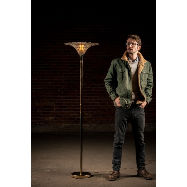 A two-toned brass and nickel lamp originating from around the middle of the 20th century. This floor lamp features a...
