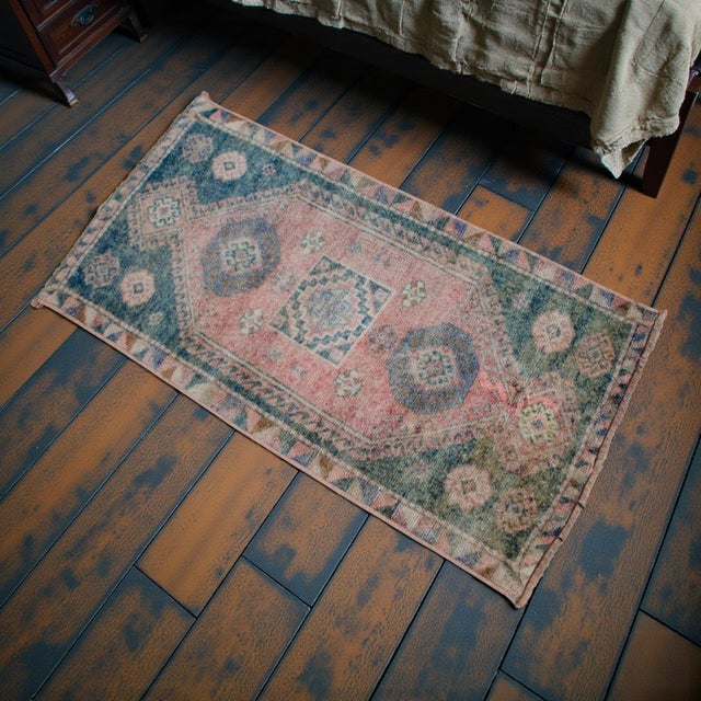 Soft, faded vintage Turkish small rug with a dusty rose field and teal-green geometric medallions - an easy accent for...
