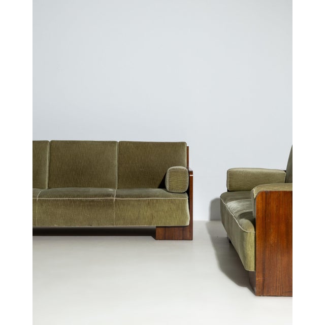Pair of upholstered sofas in Deep Olive Green. The deep olive green surface highlights clean tuxedo arms, olive green wool...