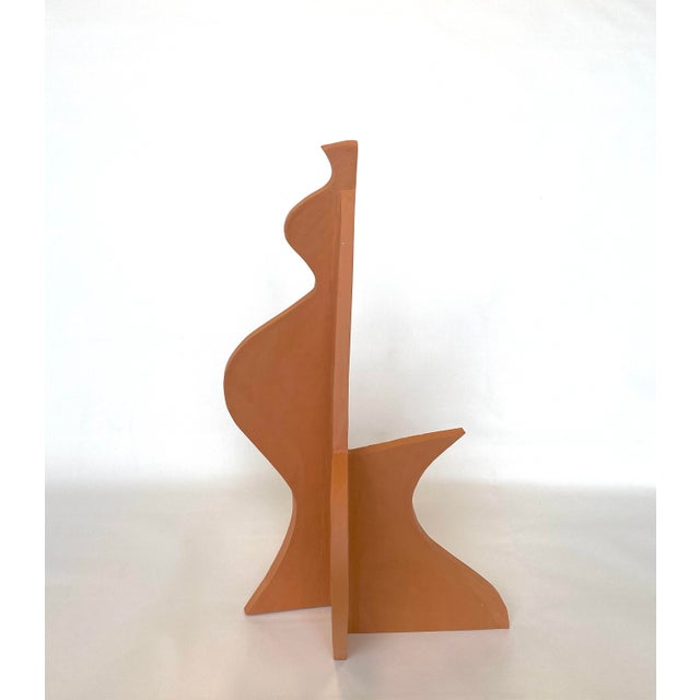 Slab built abstract sculpture in unglazed terra cotta clay by artist Emily Reynolds.
